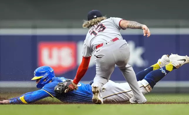 Cleveland Guardians shortstop Gabriel Arias (13) tags out Minnesota Twins' Carson McCusker (60) in the second inning of the second baseball game of a doubleheader, Saturday, Sept. 20, 2025, in Minneapolis. (AP Photo/Mike Stewart)