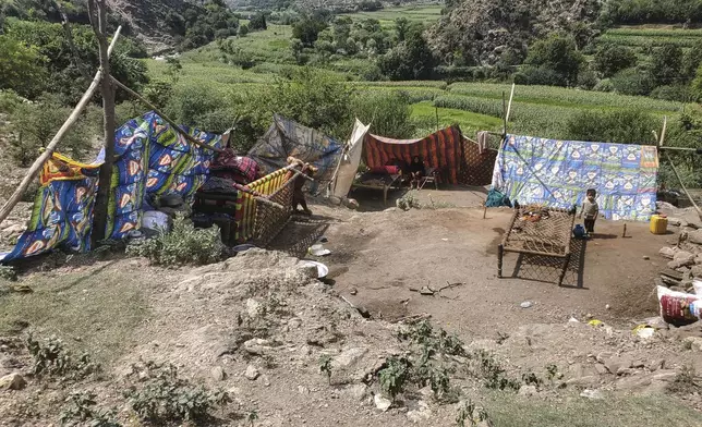 An Afghan family sets up a makeshift shelter after their home was destroyed by a powerful earthquake that struck eastern Afghanistan on Sunday, in Mazar Dara, Kunar province, Afghanistan, Wednesday, Sept. 3, 2025. (AP Photo/Hedayat Shah)