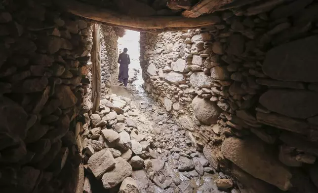 A local resident walks near a wall partially collapsed bySunday's powerful 6.0-magnitude earthquake that killed many people and destroyed villages in eastern Afghanistan, in Dara Noor, Kunar province, Tuesday, Sept. 2, 2025,. (AP Photo/Wahidullah Kakar)