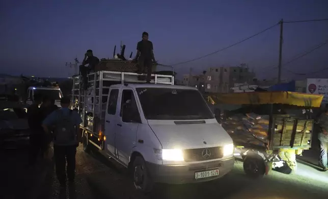 A truck transports the Abu Jarad family through Nuseirat, Gaza Strip, Sept. 10, 2025, after they were displaced from Gaza City following evacuation orders issued by the Israeli army. (AP Photo/Abdel Kareem Hana)