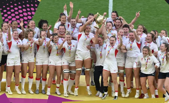 England's Zoe Aldcroft rasies the trophy after winning the Women's Rugby World Cup final match between England and Canada at the Allianz Stadium, Twickenham in London, Saturday, Sept. 27, 2025.(AP Photo/Anthony Upton)