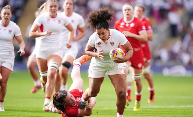 England's Tatyana Heard is tackled by Canada's Alysha Corrigan during the Women's Rugby World Cup final match between England and Canada at the Allianz Stadium, Twickenham, London, Saturday, Sept. 27, 2025. (Ben Whitley/PA via AP)