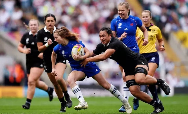 France's Pauline Bourdon Sansus gets away from New Zealand's Layla Sae, center right, during the Women's Rugby World Cup bronze match between New Zealand and France at the Allianz Stadium, Twickenham, London, Saturday, Sept. 27, 2025. (Ben Whitley/PA via AP)