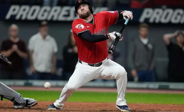 Cleveland Guardians' David Fry falls back after being hit in the face with his own bunt in the sixth inning of a baseball game against the Detroit Tigers in Cleveland, Tuesday, Sept. 23, 2025. (AP Photo/Sue Ogrocki)