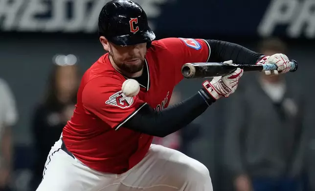 Cleveland Guardians' David Fry is hit in the face with his own bunt in the sixth inning of a baseball game against the Detroit Tigers in Cleveland, Tuesday, Sept. 23, 2025. (AP Photo/Sue Ogrocki)
