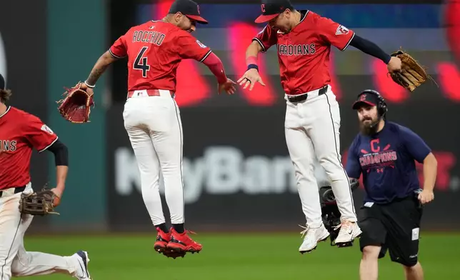 Cleveland Guardians' Brayan Rocchio (4) and left fielder Steven Kwan, right, celebrate after the Guardians defeated the Detroit Tigers in ia baseball game in Cleveland, Tuesday, Sept. 23, 2025. (AP Photo/Sue Ogrocki)