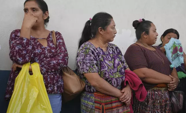 Relatives of unaccompanied minors deported from the United States await updates outside La Aurora International Airport, in Guatemala City, Sunday, Aug. 31, 2025. (AP Photo/Moises Castillo)