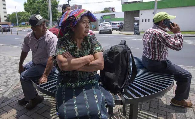 People wait for loved ones from Guatemala deported from the United States outside La Aurora International Airport, in Guatemala City, Sunday, Aug. 31, 2025. (AP Photo/Moises Castillo)
