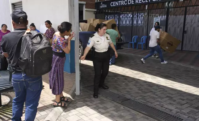 People wait for loved ones from Guatemala deported from the United States outside La Aurora International Airport, in Guatemala City, Sunday, Aug. 31, 2025. (AP Photo/Moises Castillo)