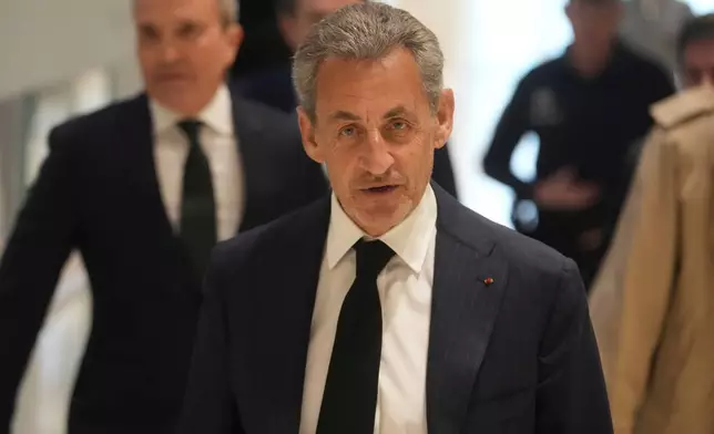 FILE - Former French President Nicolas Sarkozy arrives as he goes on trial over alleged illegal financing of his 2007 presidential campaign by the government of late Libyan leader Moammar Gadhafi, Monday, Jan. 6, 2025 in Paris. (AP Photo/Thibault Camus, File)
