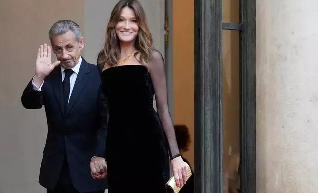 FILE - Former French President Nicolas Sarkozy and his wife Carla Bruni Sarkozy arrive at the Elysee Palace before a state dinner hosted by French President Emmanuel Macron for Brazil's President Luiz Inacio Lula da Silva Thursday, June 5, 2025 in Paris. (AP Photo/Michel Euler, File)
