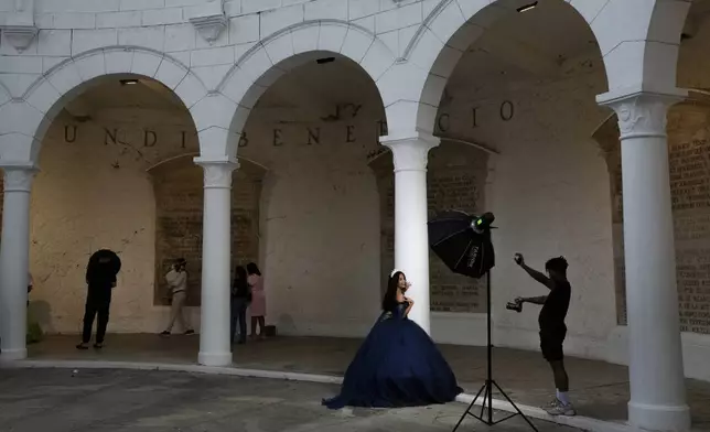 A young woman poses for photos inside a former bastion that was part of the colonial defenses against pirates in Casco Viejo, the historic district of Panama City, also a UNESCO World Heritage Site, Sunday, Aug. 10, 2025. (AP Photo/Matias Delacroix)