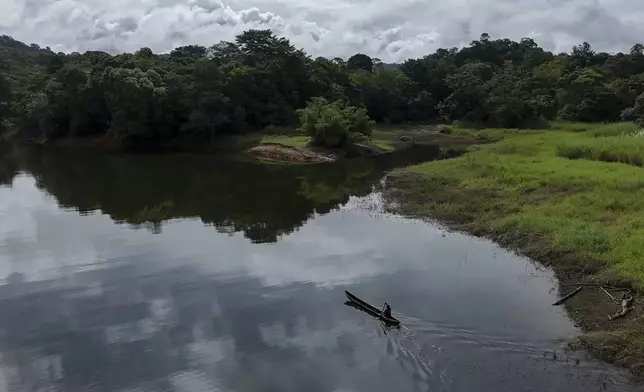 A man paddles along the Chagres River, once the main colonial waterway crossing Panama and connecting the Pacific with Caribbean, Saturday, Aug. 16, 2025. (AP Photo/Matias Delacroix)