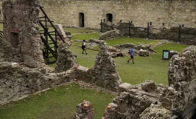 Visitors tour Fort San Lorenzo, a 16th-century Spanish fortress guarding the mouth of the Chagres River, once the main colonial waterway linking the Pacific and Caribbean, in Colon, Panama, Tuesday, Aug. 12, 2025. (AP Photo/Matias Delacroix)