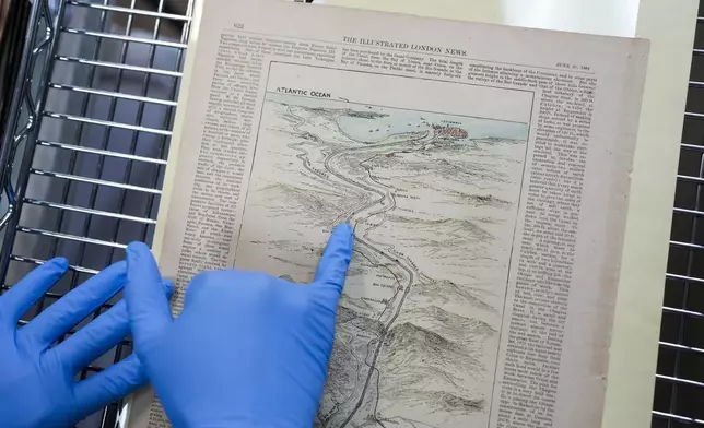 Researcher Esteban Zabala presents an 1888 map of the world's first transcontinental railway, a document that also included early canal route proposals, at the Panama Canal Museum in Panama City, Wednesday, Aug. 13, 2025. (AP Photo/Matias Delacroix)