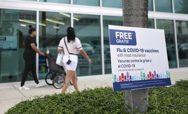Vaccines are advertised outside a pharmacy in Miami, Thursday, Sept. 4, 2025. (AP Photo/Rebecca Blackwell)