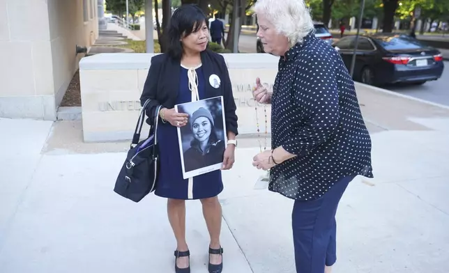 Clariss Moore of Toronto, holds a photo of her deceased daughter Danielle as she talks with Susan Riffel, who also also lost sons Melvin and Bennett is Boeing crash, before a hearing at federal court in Fort Worth, Texas, Wednesday, Sept. 3, 2025. (AP Photo/LM Otero)