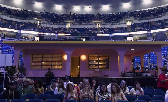 Fans sit in front of "La Casita" before Bad Bunny final concert of his summer residency in his homeland at the Coliseo de Puerto Rico Jose Miguel Agrelot, in San Juan, Puerto Rico, Saturday, Sept. 20, 2025. (AP Photo/Alejandro Granadillo)