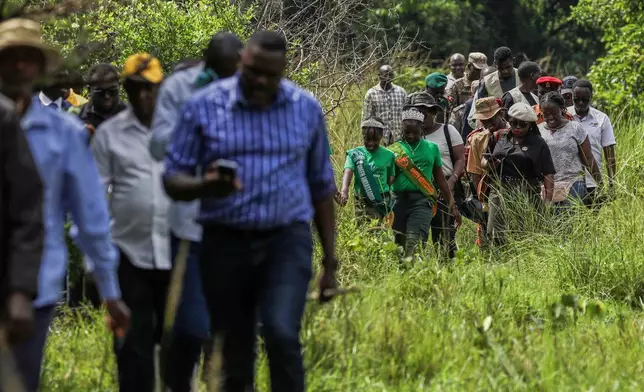 Members of the public and volunteers participate in rhino tracking at the Ziwa Rhino Sanctuary, northwest of Nakasongola, Uganda, Monday, Sept. 22, 2025. (AP Photo/Hajarah Nalwadda)