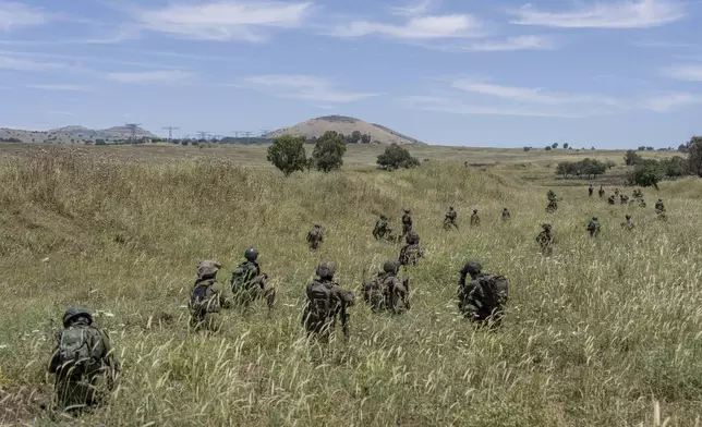 FILE - Israeli combat reservists take position during training in the Israeli-controlled Golan Heights on May 8, 2024. (AP Photo/Ohad Zwigenberg, File)