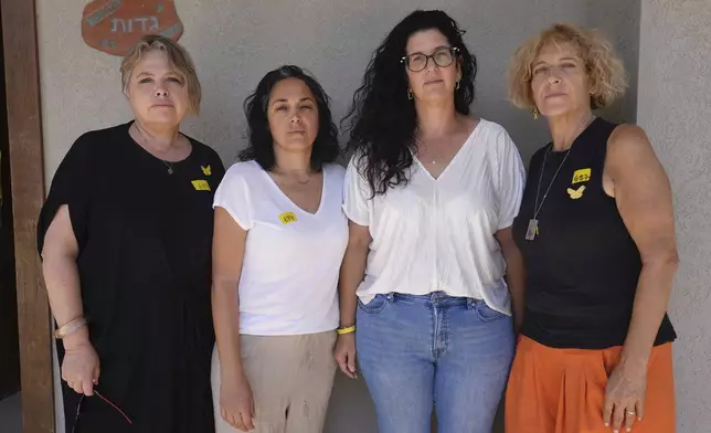From left: Noorit Felsenthal-Berger, Bat El, Yifat Gadot, Paula Keusch, mothers of soldiers who have fought in Gaza, pose for a photo outside a house in Tal Shahar, central Israel, Saturday Aug. 23, 2025. (AP Photo/Sam Mednick)
