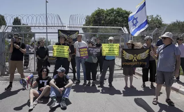 FILE - Relatives and supporters of Israeli soldier Daniel Yahalom, who was jailed for refusing to fight in Gaza, call for an end to the war outside the Beit Lid military base in central Israel on May 16, 2025. (AP Photo/Mahmoud Illean, File)