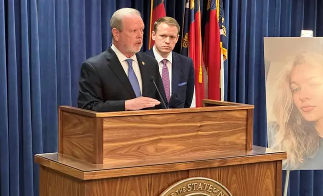 North Carolina state Senate leader Phil Berger, R-Rockingham, left, speaks while House Speaker Destin Hall, R-Caldwell, listens and stands next to a photo of commuter train stabbing victim Iryna Zarutska, during a Legislative Building news conference, in Raleigh, N.C., Thursday, Sept. 11, 2025. (AP Photo/Gary D. Robertson)