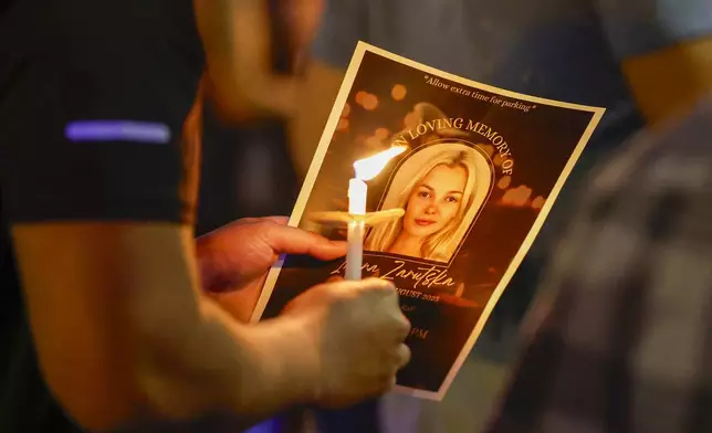 Community members gather for a vigil honoring the life of Iryna Zarutska, who was fatally stabbed on a commuter train last month, Monday, Sept. 22, 2025, in Charlotte, N.C. (AP Photo/Nell Redmond)