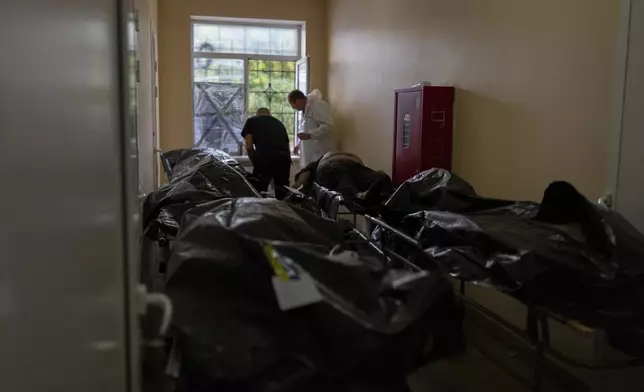 Bodies of civilians killed in a Russian aerial attack on village of Yarova, are seen at a morgue in Donetsk region, Tuesday, Sept. 9, 2025. (AP Photo/Alex Babenko)