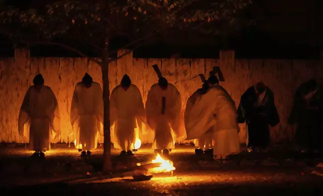 Shinto priests participate in Konomotosai, a night ceremony of the Shikinen Sengu ritual, which concludes in 2033, at the Ise Jingu shrine complex in Ise, central Japan, Friday, May 2, 2025. (AP Photo/Hiro Komae)