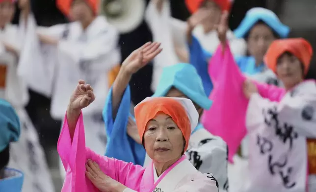People dance in celebration of Mihishirogi Hoeishiki, a ceremony of the Shikinen Sengu ritual to rebuild main structures of the Ise Jingu shrine complex for Shinto deities, in Ise, central Japan, Monday, June 9, 2025. (AP Photo/Hiro Komae)