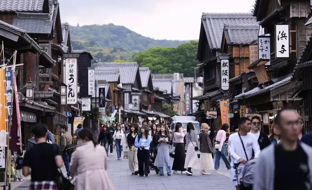 People visit a shopping street near the Ise Jingu shrine complex in Ise, central Japan, Thursday, May 1, 2025. (AP Photo/Hiro Komae)