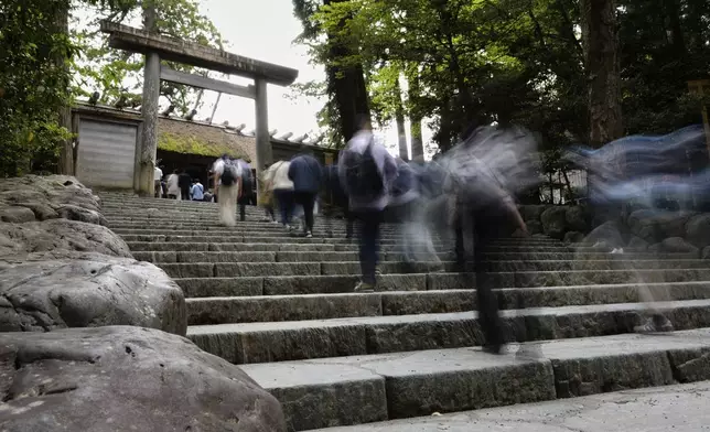 Visitors walk upstairs to visit the main palace at Kotaijingu, also known as Naiku, or the inner sanctuary, of the Jingu shrine complex in Ise, central Japan, Thursday, May 1, 2025. (AP Photo/Hiro Komae)