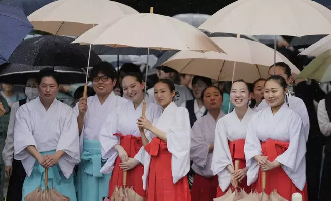 Officials in the Shinto priesthood watch a Japanese traditional dance in celebration of Mihishirogi Hoeishiki, a ceremony of the Shikinen Sengu ritual to rebuild main structures of the Ise Jingu shrine complex for Shinto deities, in Ise, central Japan, Monday, June 9, 2025. (AP Photo/Hiro Komae)