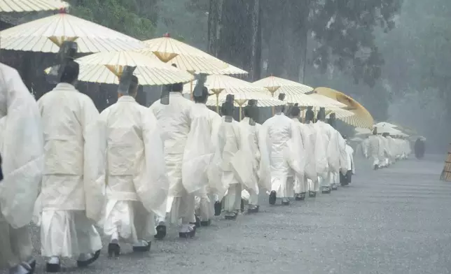 Priests and officials in the Shinto priesthood participate in Yamaguchisai, a kickoff ceremony of Shikinen Sengu, which concludes in 2033, at the Ise Jingu shrine complex in Ise, central Japan, Friday, May 2, 2025. (AP Photo/Hiro Komae)