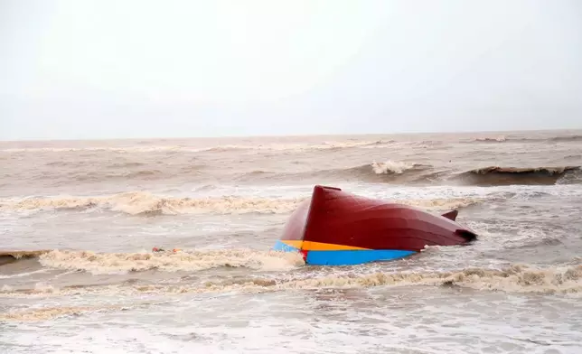 A boat is washed ashore in Quang Tri, Vietnam, Monday, Sept. 29, 2025, after Typhoon Bualoi went through the area. (Vo Ta Chuyen/VNA via AP)