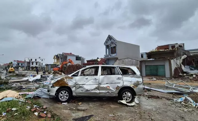 A damaged car is seen amid debris and other damaged buildings after Typhoon Bualoi swept through Thanh Hoa, Vietnam, Monday, Sept. 29, 2025. (Viet Hoang/VNExpress via AP)