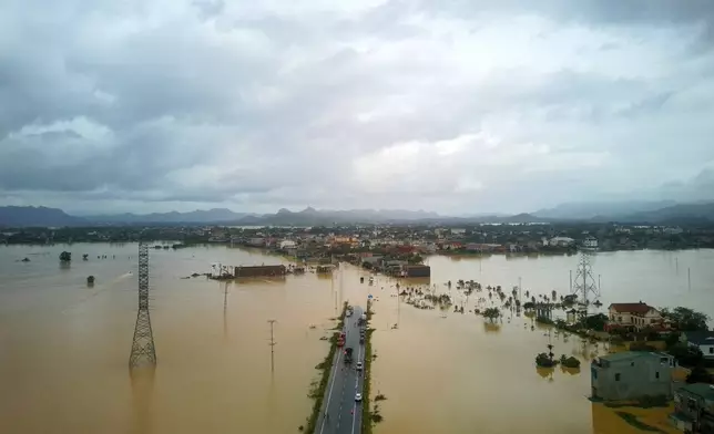 This aerial photo shows flooding caused by rain following typhoon Bualoi in Thanh Hoa, Vietnam, Tuesday, Sept. 30, 2025. (Tran Van Hoang/VNA via AP)