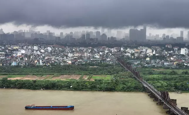 Dark clouds hang over the Hanoi skyline and the Red River after Typhoon Bualoi swept across the country, in Hanoi, Vietnam, Monday, Sept. 29, 2025. (AP Photo/Dan Dockery)