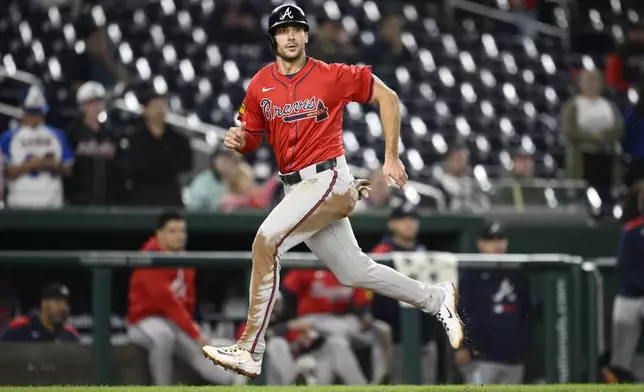 Atlanta Braves' Matt Olson runs towards home to score on a sacrifice fly by Ozzie Albies during the 10th inning of the second baseball game of a doubleheader against the Washington Nationals Tuesday, Sept. 16, 2025, in Washington. (AP Photo/Nick Wass)