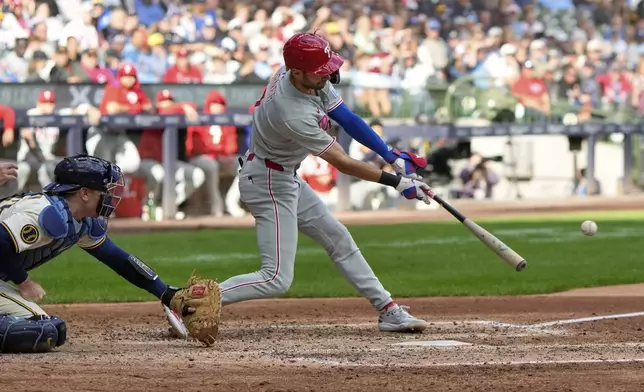 Philadelphia Phillies' Trea Turner hits an RBI single during the seventh inning of a baseball game against the Milwaukee Brewers Thursday, Sept. 4, 2025, in Milwaukee. (AP Photo/Morry Gash)