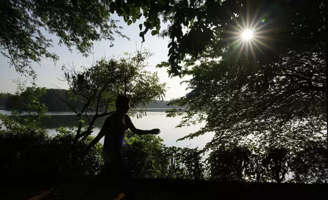 A man takes a morning walk at Jakkur Lake in Bengaluru, India, Tuesday, Sept. 9, 2025. (AP Photo/Aijaz Rahi)