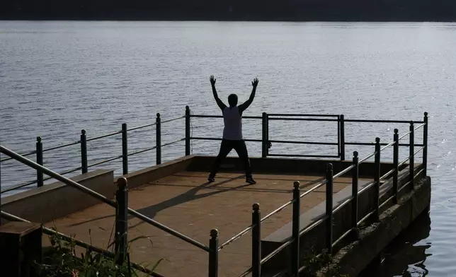 A man does morning exercises at Jakkur Lake in Bengaluru, India, Tuesday, Sept. 9, 2025. (AP Photo/Aijaz Rahi)