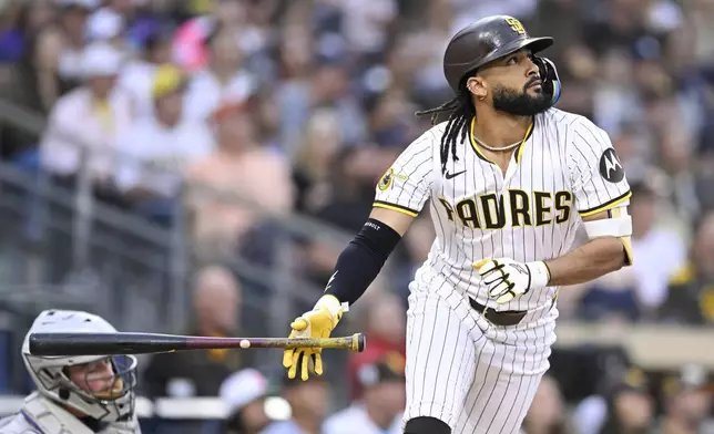 San Diego Padres' Fernando Tatis Jr. (23) hits a solo home run during the second inning of a baseball game against the Colorado Rockies Saturday, Sept. 13, 2025, in San Diego. (AP Photo/Denis Poroy)