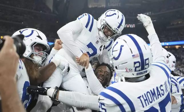 Indianapolis Colts place kicker Spencer Shrader (3) celebrates with teammates after kicking the game winning field goal during the second half an NFL football game against the Denver Broncos, Sunday, Sept. 14, 2025, in Indianapolis. (AP Photo/Michael Conroy)