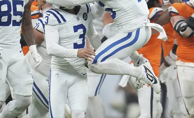 Indianapolis Colts long snapper Luke Rhodes (46) celebrates with place kicker Spencer Shrader (3) after Shrader kicked a game winning field goal during the second half an NFL football game against the Denver Broncos, Sunday, Sept. 14, 2025, in Indianapolis. (AP Photo/Michael Conroy)