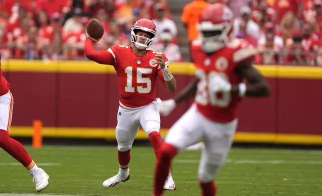 Kansas City Chiefs quarterback Patrick Mahomes (15) throws during the first half of an NFL football game against the Philadelphia Eagles Sunday, Sept. 14, 2025, in Kansas City, Mo. (AP Photo/Charlie Riedel)