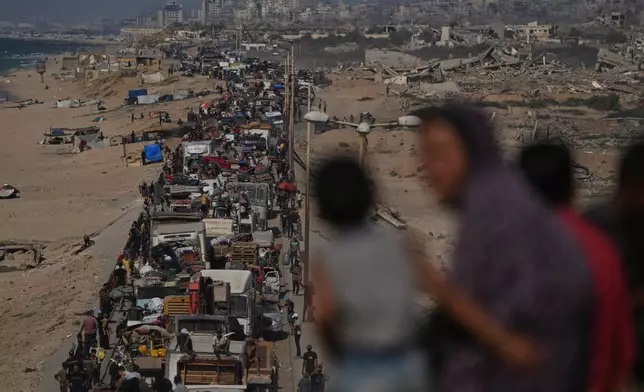 Displaced Palestinians flee northern Gaza Strip, by foot and in vehicles, carrying their belongings along the coastal road, near Wadi Gaza, Tuesday, Sept. 23, 2025. (AP Photo/Abdel Kareem Hana)