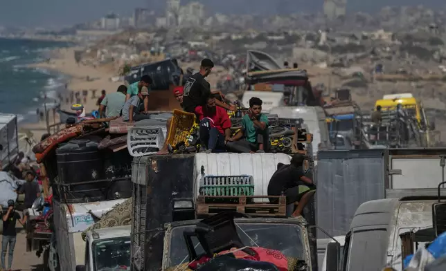 Displaced Palestinians flee northern Gaza Strip, by foot and in vehicles, carrying their belongings along the coastal road, near Wadi Gaza, Tuesday, Sept. 23, 2025. (AP Photo/Abdel Kareem Hana)