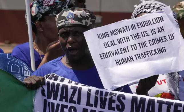 A member of Eswatin Pro-democracy activists, holds a placard at they protest outside the U.S. Embassy in Pretoria, South Africa, Friday, Sept. 19, 2025. (AP Photo/Themba Hadebe)